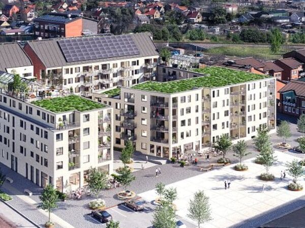 Visualisering från ovan av större bostadskomplex med innergård och gröna ytor.