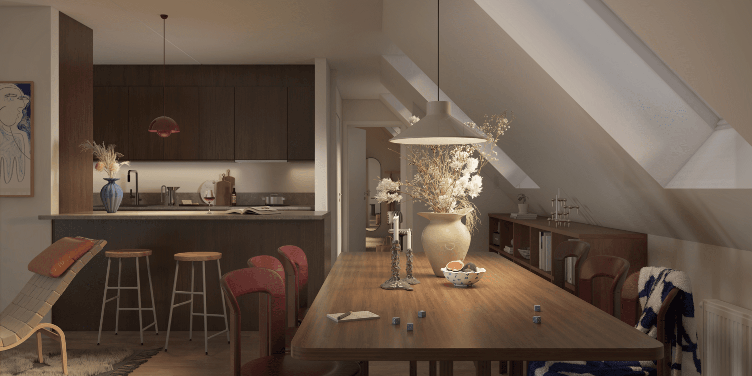 Ett kök och matplats i snedtaksmiljö visas i en av vindsvåningarna i Ängsrum, Ytterby där trädetaljer och moderna ytor möts, och GBJ bostad har utformat rummet för både matlagning och umgänge i en varm och inbjudande atmosfär.
