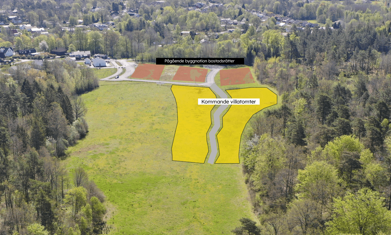 Flygbild över villatomter, Nättraby, där GBJ bostad planerar ett nytt bostadsområde med markerade villatomter längs en intern väg. Omgivande skog, öppna gräsytor och närliggande bebyggelse visar områdets naturnära läge och framtida utvecklingspotential.